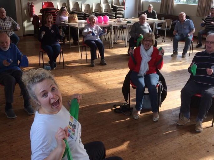 Exercise class showing the instructor and attendees enjoying themselves.