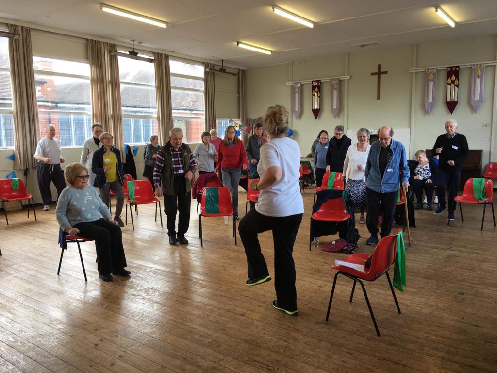 Exercise class showing attendees taking part in a walking exercise